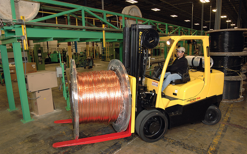 Electric forklift moving palletised goods in a Singapore warehouse