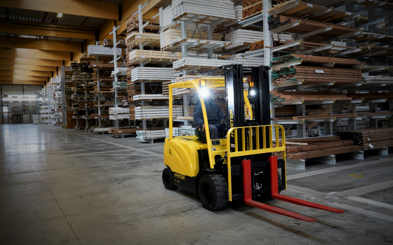 Warehouse staff reviewing forklift battery operations in a Singapore logistics facility
